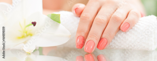 Manicure concept. Beautiful woman's hand with perfect manicure at  beauty salon. photo