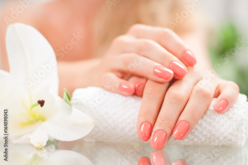 Manicure concept. Beautiful woman's hands with perfect manicure at  beauty salon.