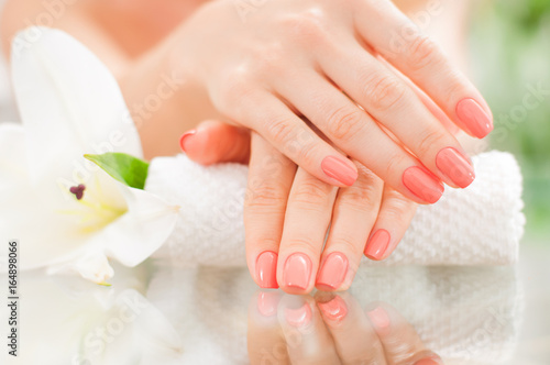 Manicure concept. Beautiful woman s hands with perfect manicure at  beauty salon.