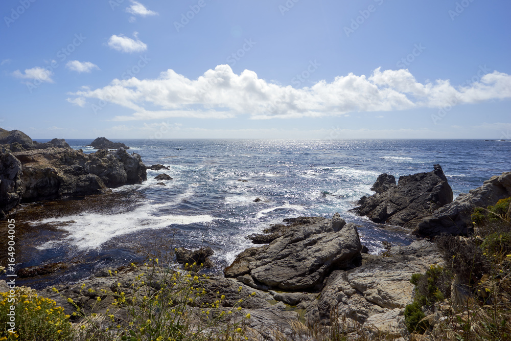 View from above a rocky cove westwared into the horizon above the California Pacific
