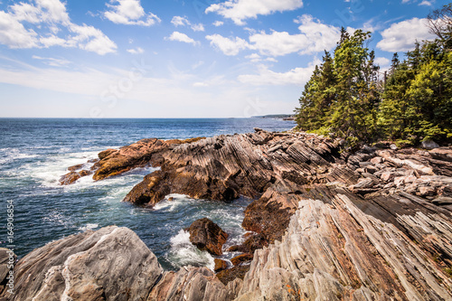 Scenic rocky shoreline in La Verna Preserve in Bristol, Maine, on a beautiful summer day