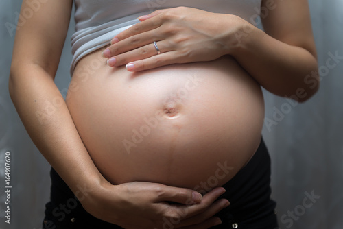 Pregnant woman touch her tummy