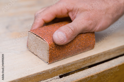 Sanding with a sanding block photo