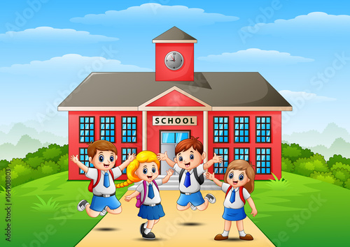 Happy school children in front of school building
