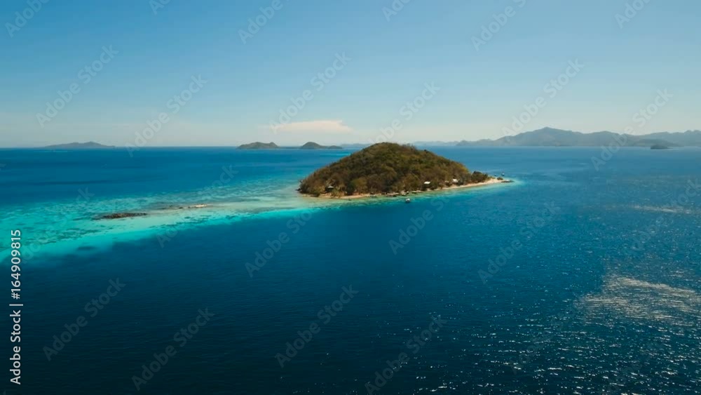 Aerial view of tropical beach on the island Banana, Philippines. Beautiful tropical island with sand beach, palm trees. Tropical landscape: beach with palm trees. Seascape: Ocean, sky, sea. 4K video Aerial view of tropical beach on the island Banana, Philippines. Beautiful tropical island with sand beach, palm trees. Tropical landscape: beach with palm trees. Seascape: Ocean, sky, sea. 4K video