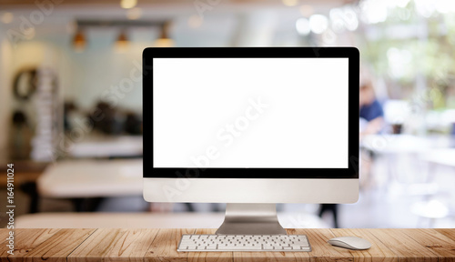 Work place concept : Mock up Blank screen computer desktop with keyboard in cafe or co-working background. photo