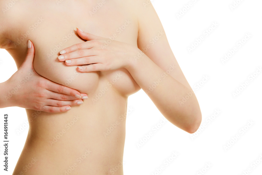 Fototapeta premium Woman examining her breasts for breast cancer