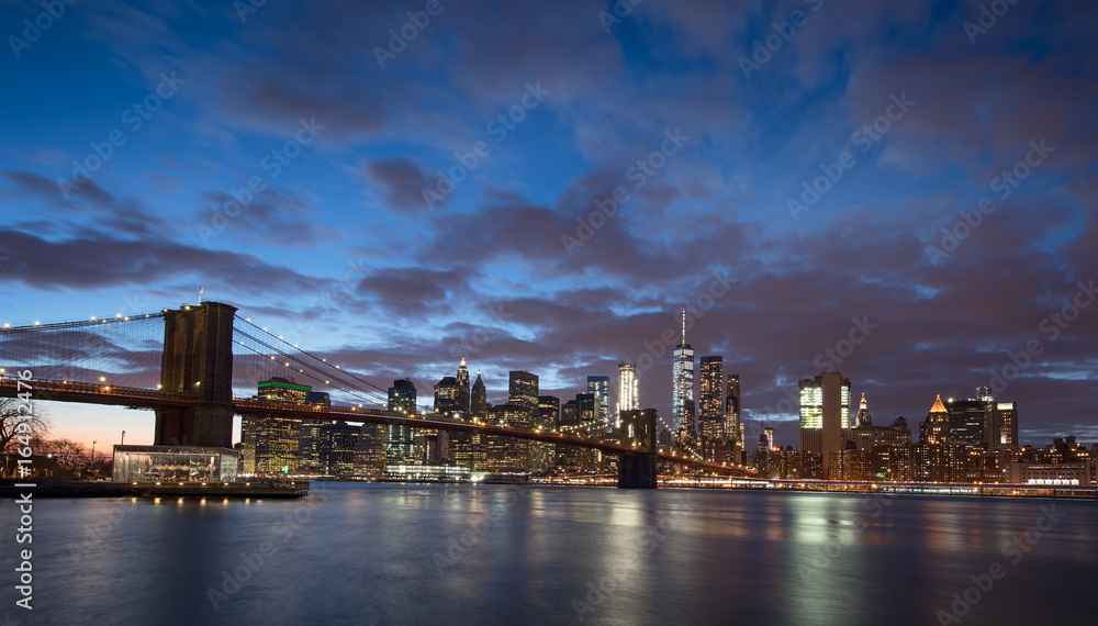New York City and Brooklyn Bridge at sunset