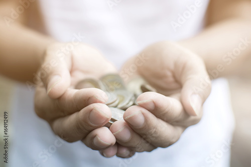 Close up hand of man holding a pile of coins by two hand, Thai coins