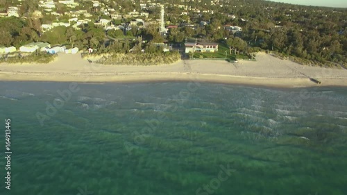 Forward flight with camera tilt upwards revealing McCrae Lighthouse at sunset. Melbourne, Australia photo