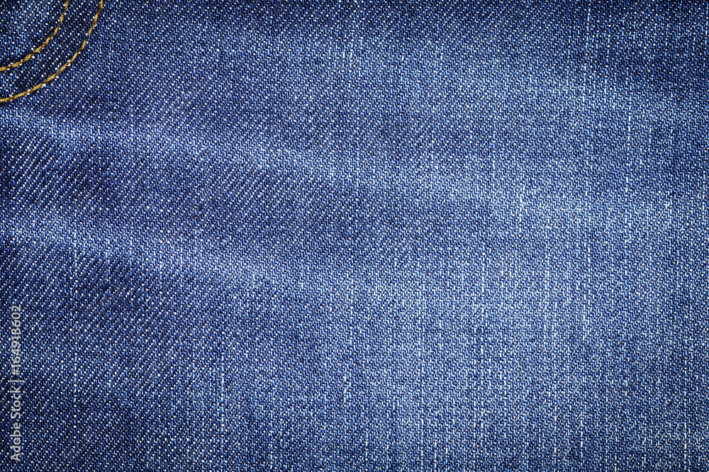 Naklejka premium Denim jeans fabric texture background with seam for beauty, fashion and clothing idea concept design.