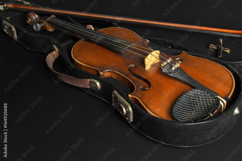 Fototapeta premium Old violin on a black background