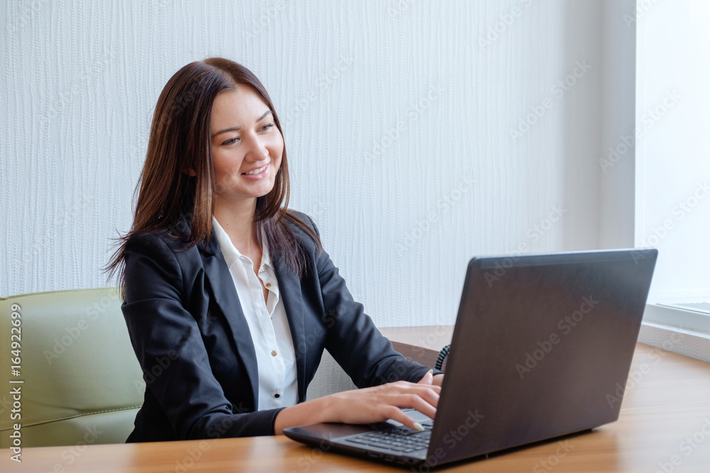 Attractive woman working in office on laptop Attractive woman working in office on laptop