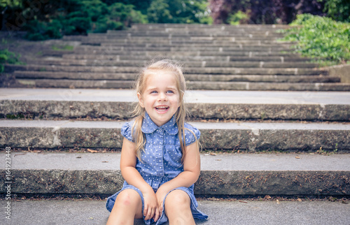 little girl smiling in a park © Irina