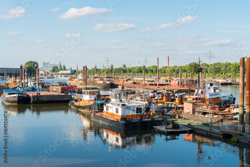 The Travehafen basin in the Steinwerder district of Hamburg. The port is a harbor basin for river vessels. Plenty of barges lies at the pier. The Travehafen is a river port, inside the deep water port