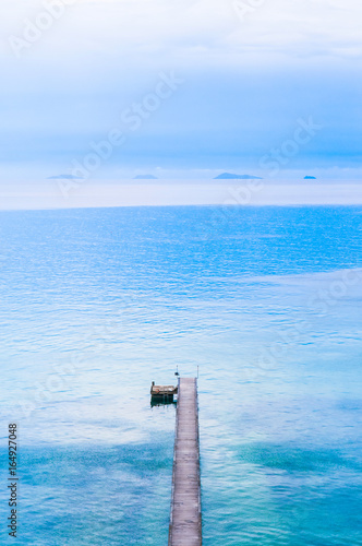 Woodden pier bridge, wooden jetty stretches out into the sea, Samui Island, Thailand