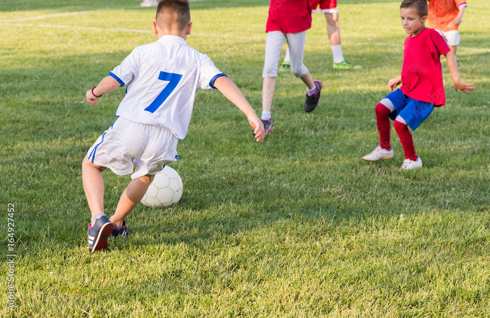 Kids soccer football - children players match on soccer field Kids soccer football - children players match on soccer field