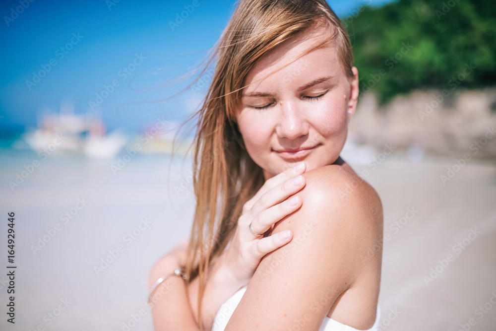 Portrait of the beautiful blond long hair woman dancing on the beach. Happy island lifestyle. White sand, blue cloudy sky and crystal sea of tropical beach. Vacation on the paradise island. Portrait of the beautiful blond long hair woman dancing on the beach. Happy island lifestyle. White sand, blue cloudy sky and crystal sea of tropical beach. Vacation on the paradise island.