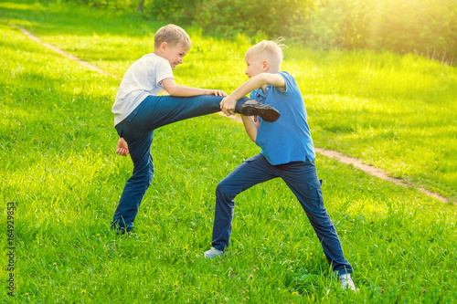 Two boys fighting in the park