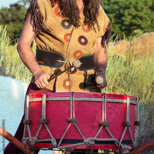 A man in ethnic clothes plays the drum, Slavs, folklore