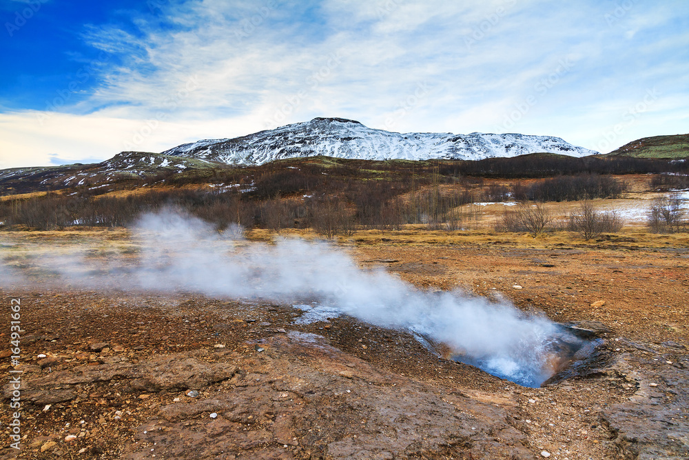 The colorful geyser landscape at the Haukadalur geothermal area, part of the golden circle route, in Iceland