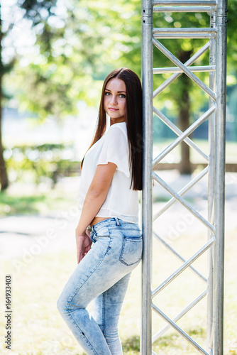 Close-up portrait of a fantastic young model girl posing in the park on a sunny day.
