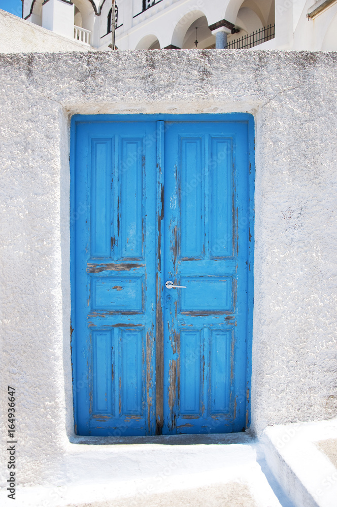 Bright blue old weathered door on the island of Santorini, Greece, Europe. Bright blue old weathered door on the island of Santorini, Greece, Europe.