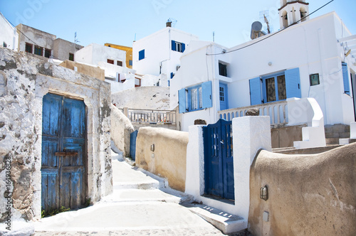Traditional greek architecture with blue doors in the city of Pyrgos on the island of Santorini, Greece, Europe. © olgaarkhipenko