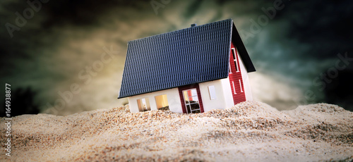 Fotografia Miniature of house standing in sand