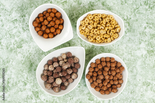 top view of various cereals in colorful bowls