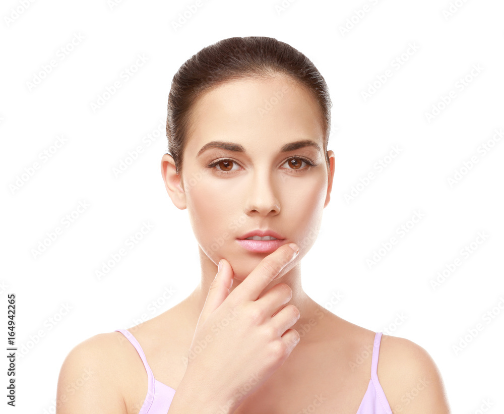 Closeup view of beautiful young woman with natural lips makeup touching face on white background Closeup view of beautiful young woman with natural lips makeup touching face on white background