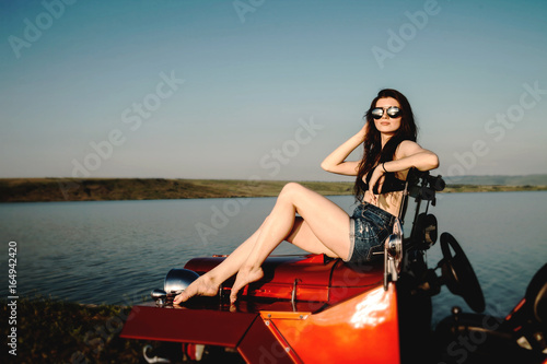 Young woman sitting on the car © esteldance