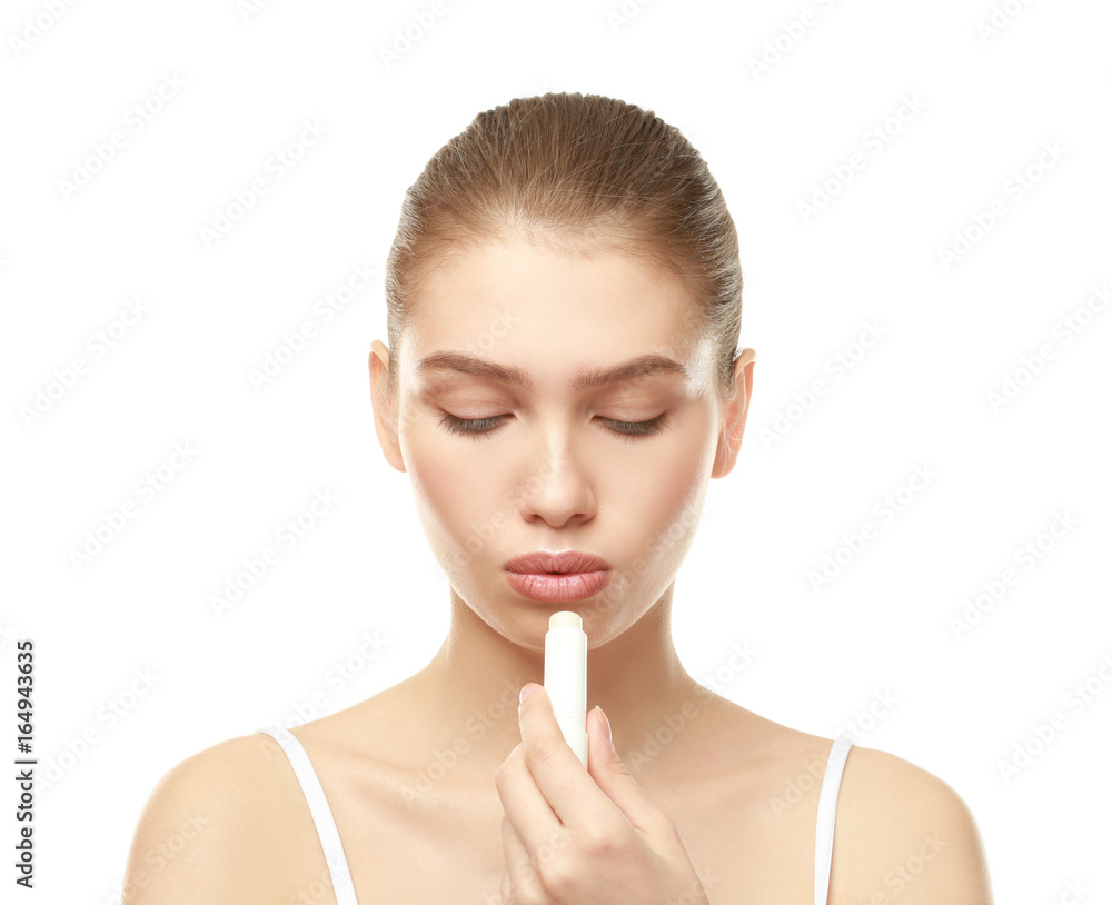 Closeup view of beautiful young woman applying lipstick, white background Closeup view of beautiful young woman applying lipstick, white background