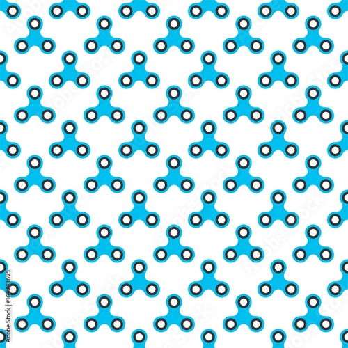 Background from blue children fidget spinners on white background. Playing backdrop of hand twisting toys with bearings in a row next to each other and alternately under him 