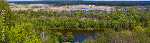 Springtime landscape banner, panorama - Desna river with flooded meadows and forests in Ukraine