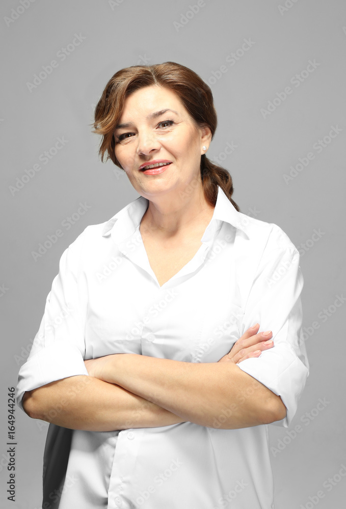 Beautiful elderly woman posing on light background Beautiful elderly woman posing on light background