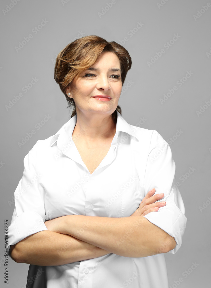 Beautiful elderly woman posing on light background Beautiful elderly woman posing on light background