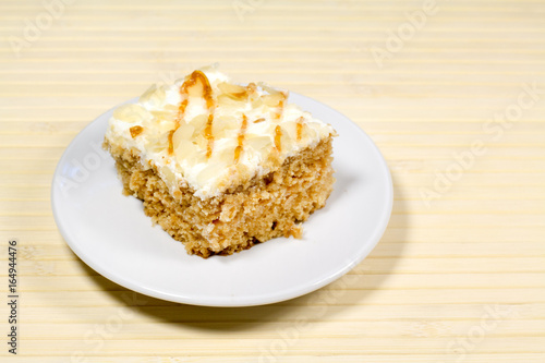 Creamy cake on plate on table