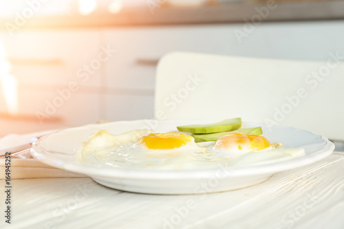 Delicious breakfast with over easy eggs on kitchen table