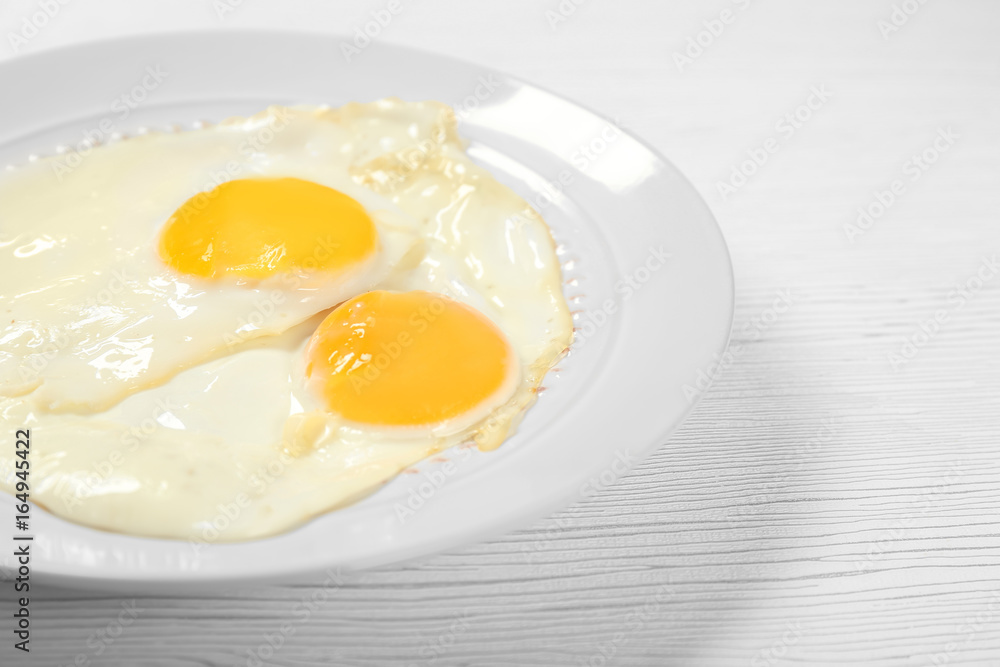 Delicious breakfast with over easy eggs on wooden background Delicious breakfast with over easy eggs on wooden background