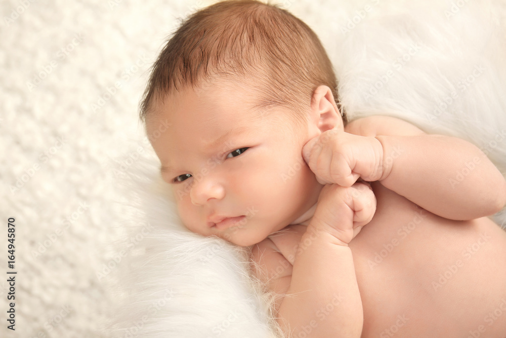 Newborn baby boy lying on soft plaid at home Newborn baby boy lying on soft plaid at home