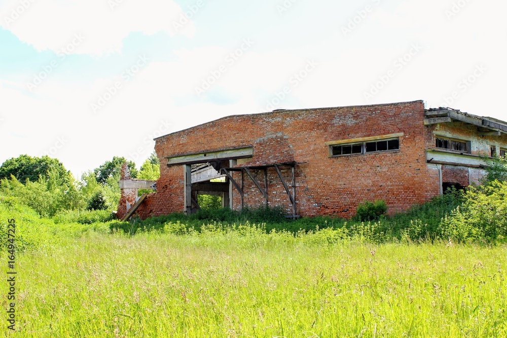 An old abandoned building of warehouse for mineral fertilizers in June 2017, Arsenyevo, Russia. An old abandoned building of warehouse for mineral fertilizers in June 2017, Arsenyevo, Russia.