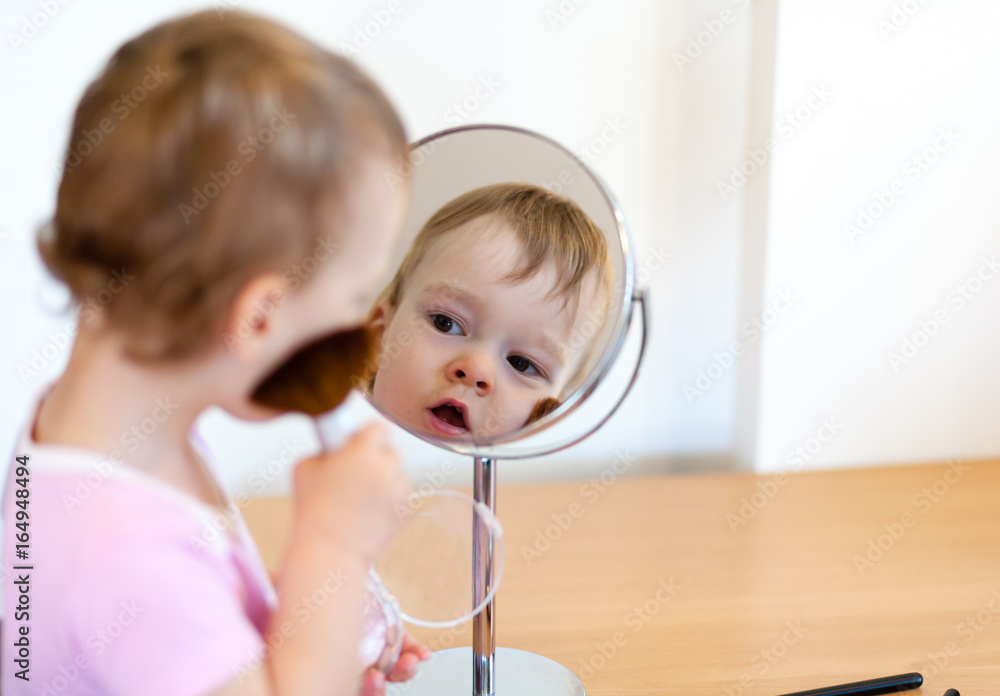 2 years old girl child is doing makeup