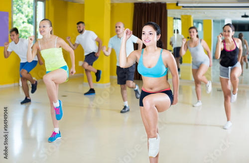 slim athletic women and men dancing strip plastic in class