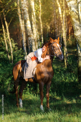 woman rides a horse in the beautiful evening park © Tortuga