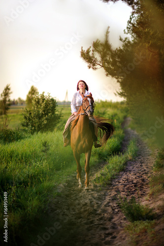 woman rides a horse in the beautiful evening park © Tortuga