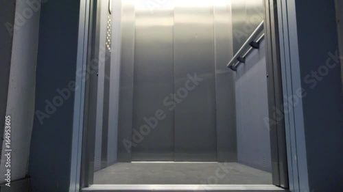 Elevator door opening and closing in a hallway