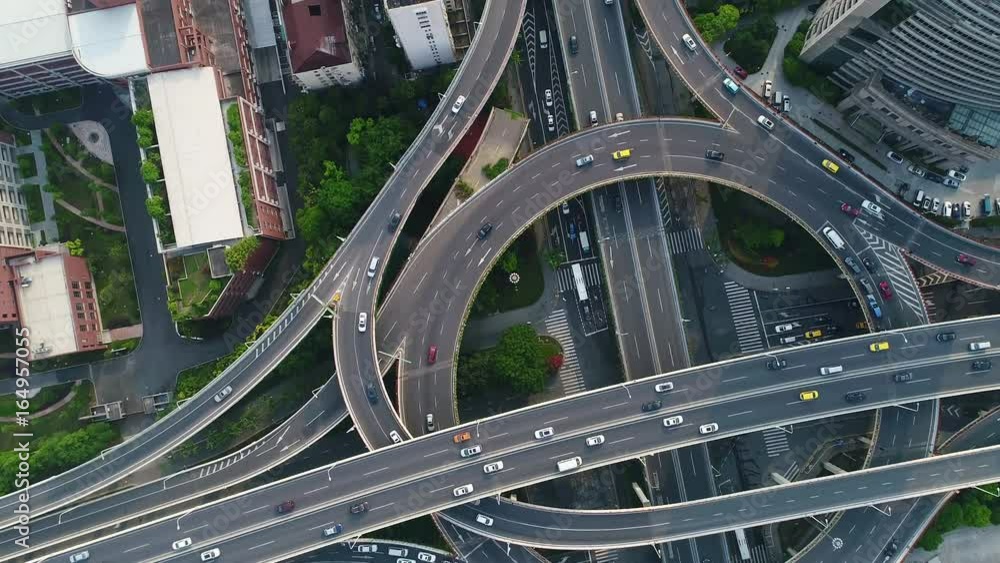 Rotating aerial top down view showing afternoon traffic on a multilevel interchange overpass and elevated road in Shanghai Rotating aerial top down view showing afternoon traffic on a multilevel interchange overpass and elevated road in Shanghai