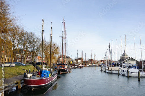 Boats and yachts in harbor of litlle historical city in Holland