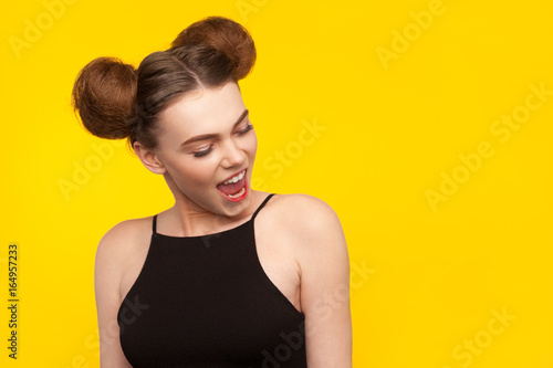 Young confident girl on yellow